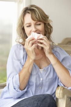Mid age woman sneezing
