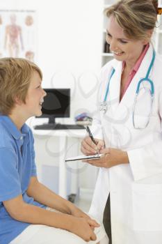 Female doctor talking to young boy