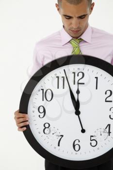 Young businessman with giant clock