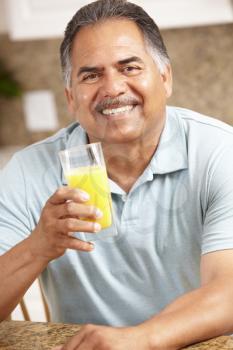 Senior man drinking orange juice