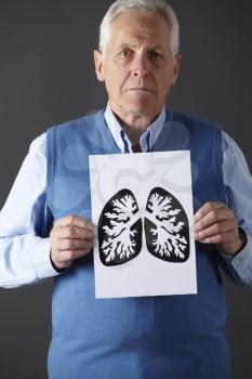 Senior man holding ink drawing of lungs