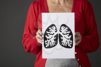 Senior woman holding ink drawing of lungs
