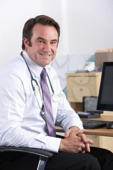 Portrait UK doctor sitting at desk