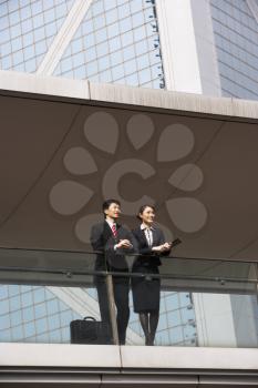 Two Business Colleagues Having Discussion Outside Office Building