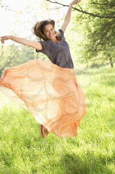 Woman Jumping In Summer Field