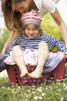Mother Carrying Son Sitting In Laundry Basket