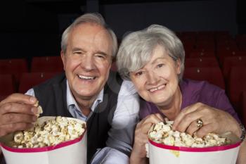 Senior Couple Watching Film In Cinema