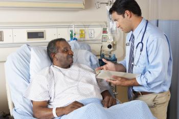 Doctor Visiting Senior Male Patient On Ward