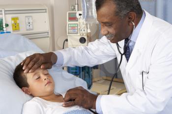 Doctor Examining Child Patient On Ward