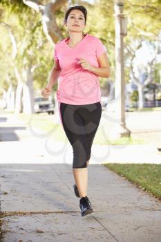 Female Runner Exercising On Suburban Street