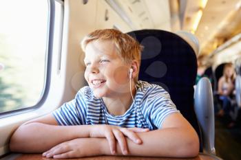 Boy Listening To Music On Train Journey