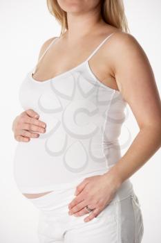 Close Up Studio 6 months Portrait Of Pregnant Woman Wearing White
