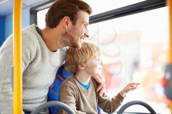 Father And Son Enjoying Bus Journey Together