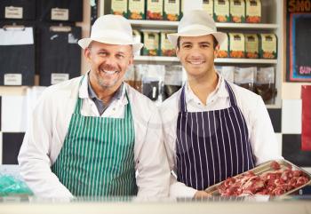 Two Butchers At Work In Shop
