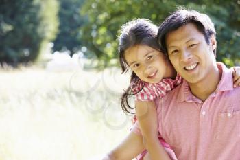 Portrait Of Asian Father And Daughter In Countryside