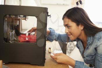 Female Architect Using 3D Printer In Office