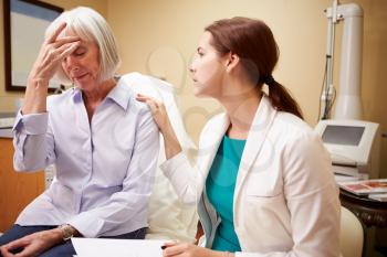 Doctor In Consultation With Senior Concerned Female Patient
