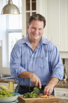 Overweight Man Preparing Vegetables in Kitchen