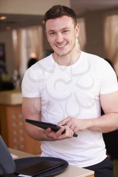 Portrait Of Waiter In Hotel Using Digital Tablet
