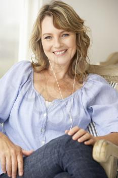 Mid age woman wearing earphones