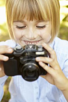 Young girl holding camera