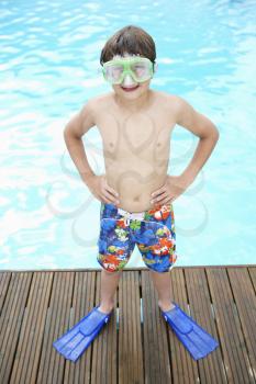 Boy by outdoor swimming pool
