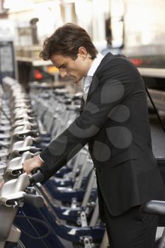 Businessman using hire bike