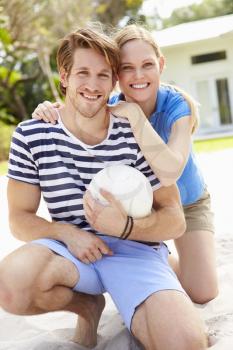 Young Couple Playing Volleyball Match