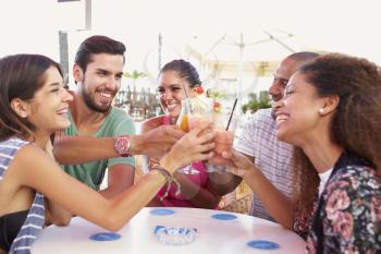Group Of Friends Drinking Cocktails At Outdoor Bar