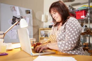 Mature Woman Checking Orders For Home Business On Laptop