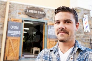 Portrait Of Hipster Barber Standing Outside Shop