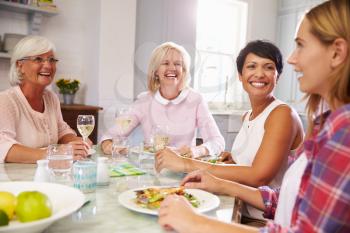 Group Of Mature Female Friends Enjoying Meal At Home