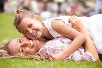 Mother And Daughter Relaxing At Outdoor Summer Event