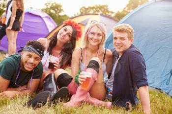 Group of friends hanging out at a music festival campsite