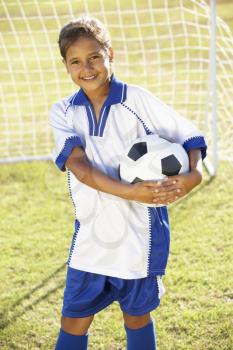 Young Girl Dressed In Soccer Kit Standing By Goal