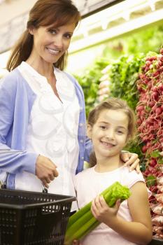 Mother And Daughteer Shopping For Produce In Supermarket
