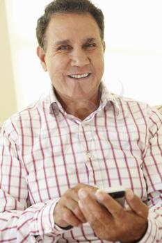 Senior Hispanic Man Using Smartphone
