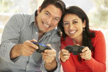 Hispanic Couple Playing Video Game At Home