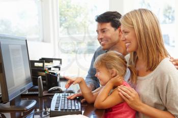 Couple working in home office with daughter