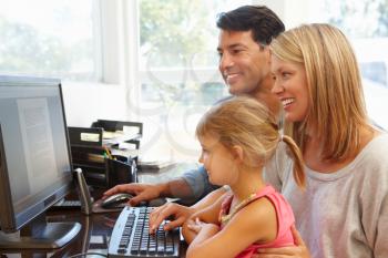 Couple working in home office with daughter