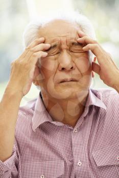 Senior Asian man with headache
