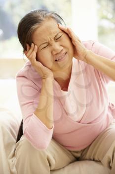 Senior Asian woman with headache