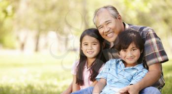 Portrait Asian grandfather and grandchildren in park