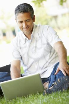 Man using laptop outdoors