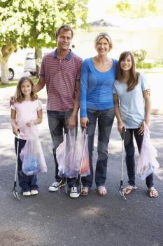 Family Picking Up Litter In Suburban Street