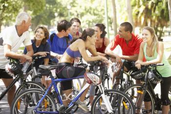 Group Of Cyclists Resting During Cycle Ride Through Park