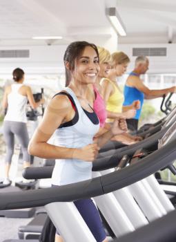 Woman On Running Machine In Gym