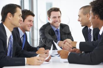 Group Of Businessmen Having Meeting In Office