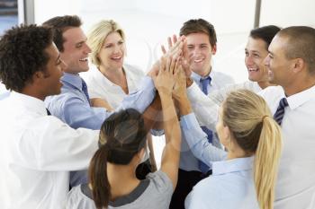 Close Up Of Business People Joining Hands In Team Building Exercise
