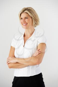 Studio Portrait Of Businesswoman Standing Against White Background